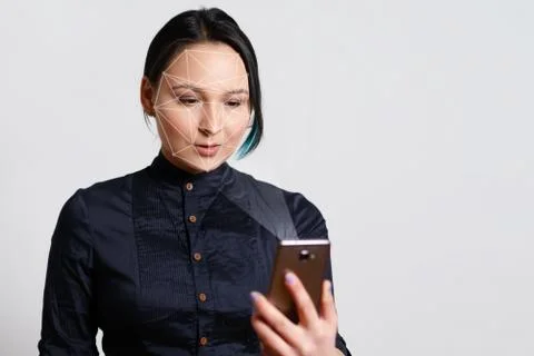 Facial Recognition System of smart phone on grey background. Biometrics conce Stock Photos