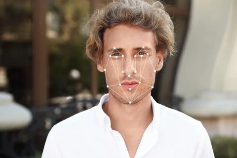Facial recognition system. Young man with digital biometric grid, outdoors 写真素材