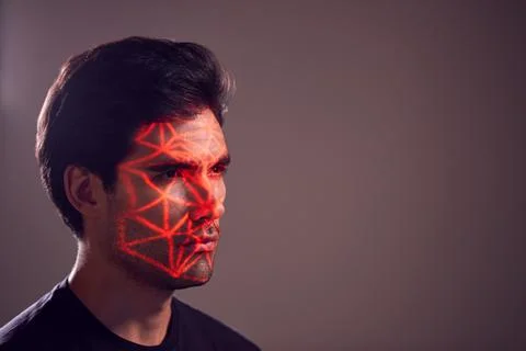 Facial Recognition Technology Concept As Man Has Red Grid Projected Onto Face In Stock Photos