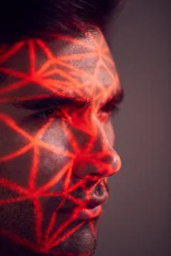 Facial Recognition Technology Concept As Man Has Red Grid Projected Onto Face In Stock Photos