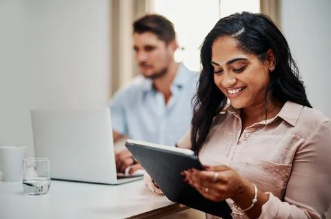 Facilitating a meeting with awesome functionality. Shot of a young businesswoman Stock Photos