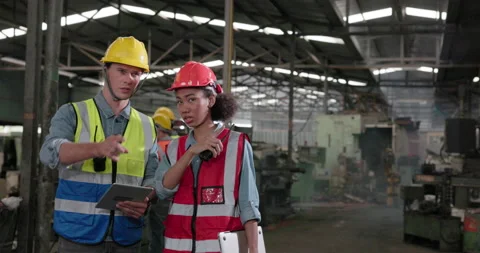 In the facility, a group of engineers and businessmen wander about and talk a Stock Footage 176233771