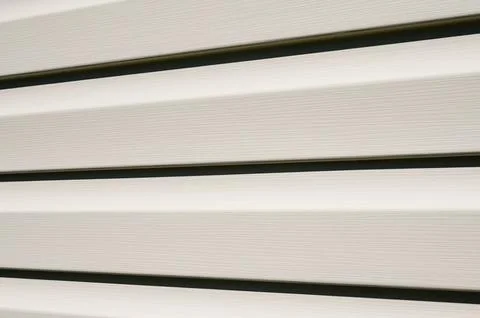 Facing beige light siding, close-up. Stock Photos
