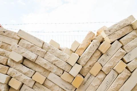 Facing bricks stacked in a warehouse building base Stock Photos