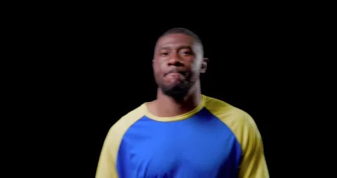 Facing camera African man raglan shirt warming rubbing gloves, bowing and Stock Footage 344851804