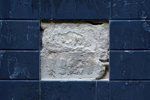 Facing plates on the wall of the building. Two Central tiles fell off. Stock Photos