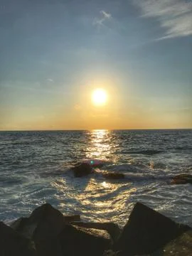 Facing the sun when its going down at the sea Stock Photos