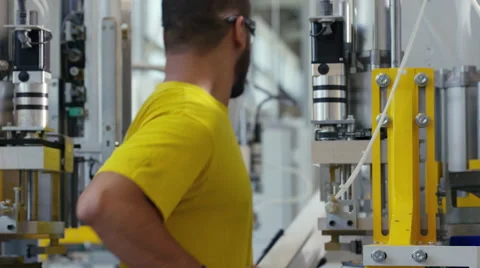 Facory worker loading a machine ready to go Stock Footage 63007952
