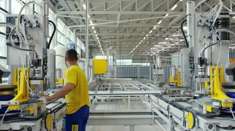 Facory worker loading a machine ready to go Stock Footage 63026034
