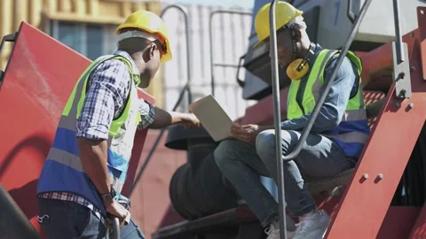 Factory African workers inspecting in front of heavy machine vehicle. Stock Footage 167833274