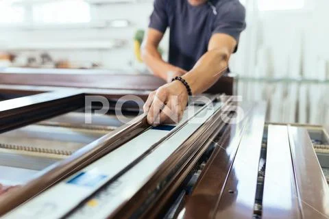 Factory for aluminum and PVC windows and doors production. Manual worker asse Stock Photos