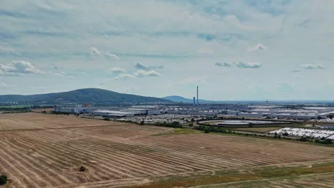 Factory and fields with hills in the background at midday Stock Footage 340382263