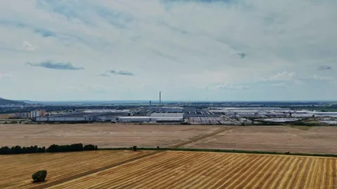 Factory and fields near a city on a cloudy day Stock Footage 340382202
