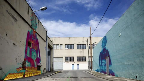 Factory and industrial complex with passing clouds and masked hacker woman Stock Footage 316625691