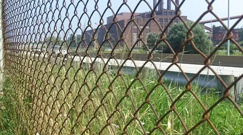 Factory and Interstate highway with traffic moving fast in the summer Stock Footage 8688494