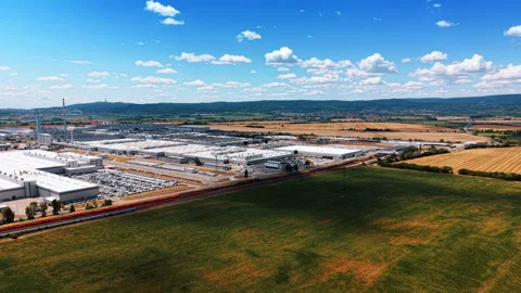 Factory and railway beyond expansive green field Stock Footage 340559369