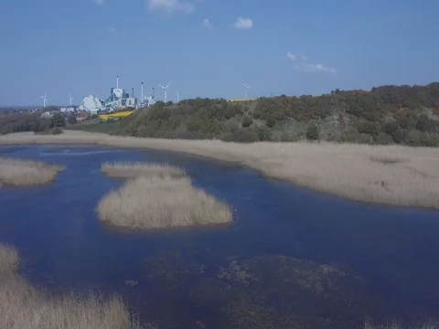 Factory and Windmills Surrounded by Countryside Stock Footage 70871492