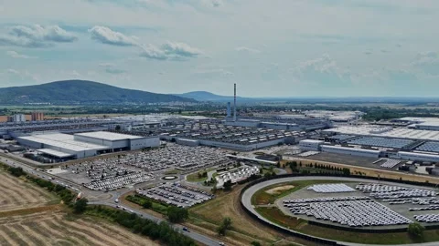 Factory area with many vehicles and green hills in the background Stock Footage 340382339