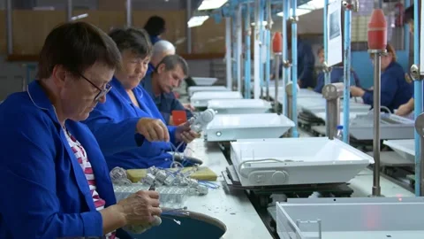 Factory assembly line assembly of electric heaters by hand. Video stock 277339509