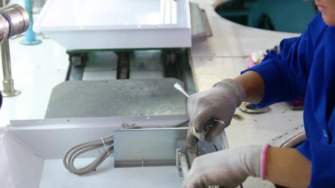 Factory assembly line assembly of electric heaters by hand. Stock Footage 277339898