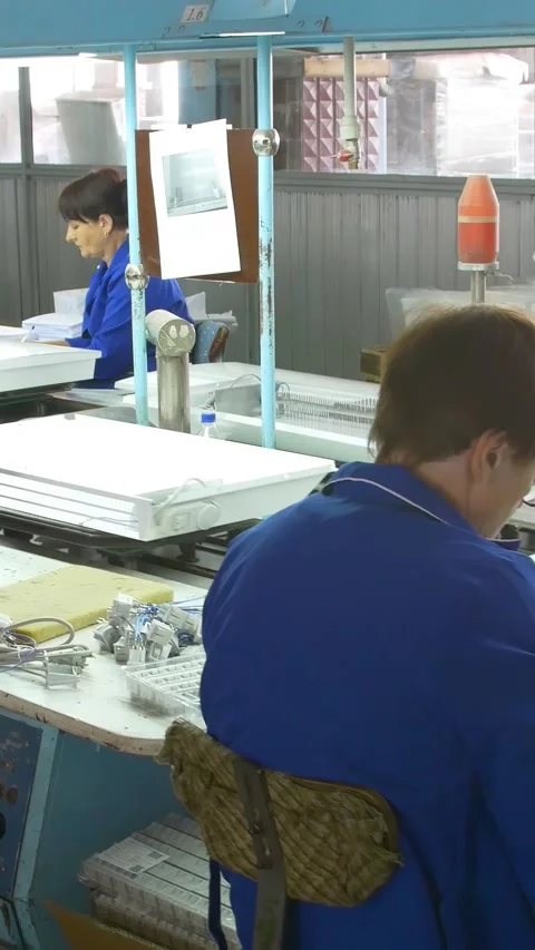 Factory assembly line assembly of electric heaters by hand. Vertical video. Stock Footage 277382647