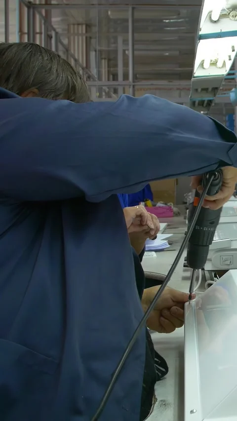 Factory assembly line assembly of electric heaters by hand. Vertical video. Stock Footage 277382680