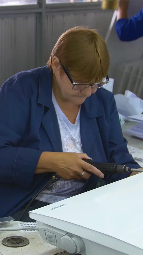 Factory assembly line assembly of electric heaters by hand. Vertical video. 動画素材 277382684