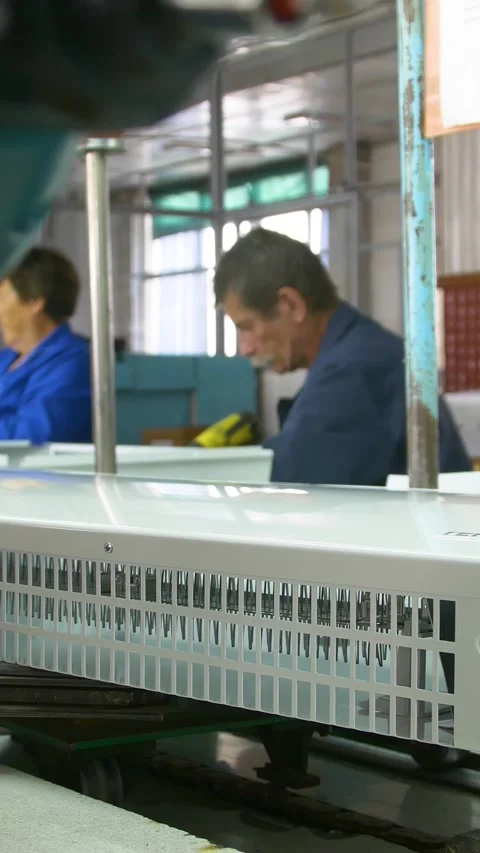 Factory assembly line assembly of electric heaters by hand. Vertical video. Video stock 277382772