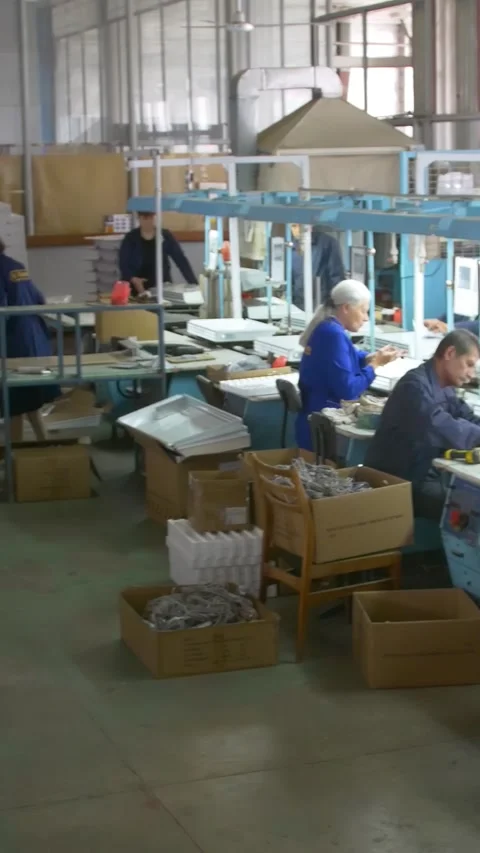Factory assembly line assembly of electric heaters by hand. Vertical video. Stock Footage 277382773