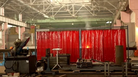 At the factory behind a red awning welded metal Stock Footage 76950959
