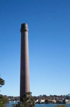 Factory brick smoke stack against blue sky Cockatoo Island Sydney Australia Stockfoto's