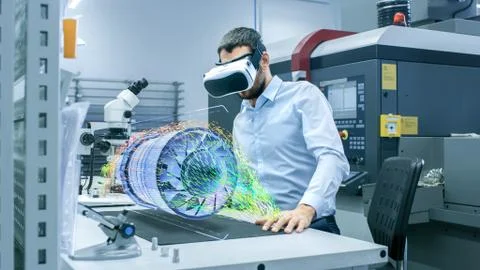 Factory Chief Engineer Wearing VR Headset Designs Engine Turbine With VR Foto stock
