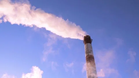 Factory chimney pipe with smoke at blue sky background Stock Footage 73483843