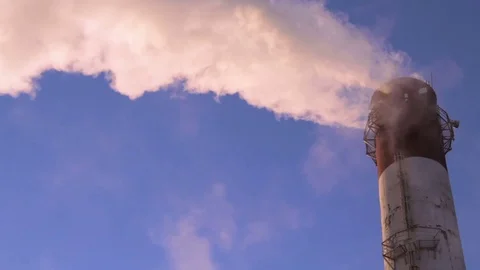 Factory chimney pipe with smoke at blue sky background Stock Footage 73483849