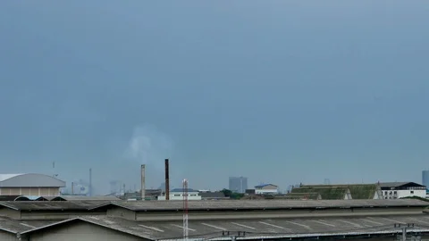 Factory chimney smoke released into the air in the community area. Stock Footage 115095768