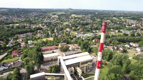 Factory chimney stack overlooking a sprawling european town landscape Stock Footage 347802015