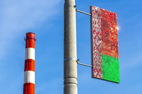 Factory chimney stack red and white and flag of Belarus. Stock Photos
