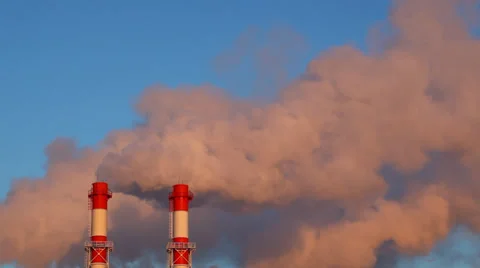 Factory chimneys with fast moving dense smoke ad dawn Stock Footage 34276315