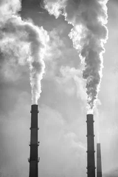 Factory chimneys smoke in cloudy sky Foto stock