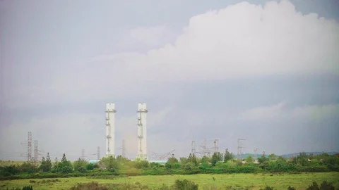 Factory chimneys_ Green landscape, clouds Stockbeeldmateriaal 88349830
