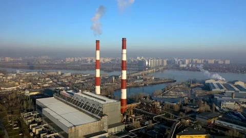Factory in the city, top view two pipes from which smoke comes. Vídeo Stock 148033145