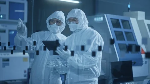 Factory Cleanroom: Engineer, Scientist Talk and Use Tablet Computer in Workshop Stock Footage 126152101