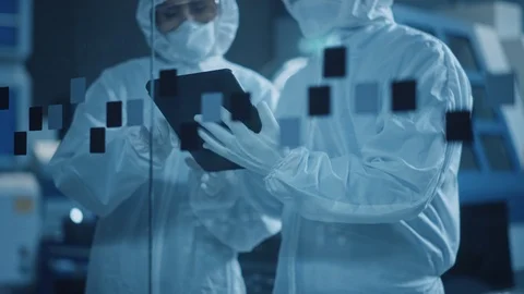 Factory Cleanroom: Engineer, Scientist Talk and Use Tablet Computer in Workshop Stock Footage 126152112