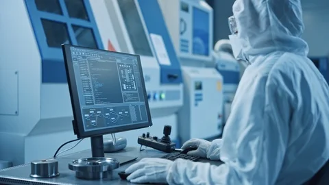 Factory Cleanroom: Engineer Wearing Coverall and Mask Does System Control on PC Stock Footage 126152180