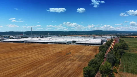 Factory complex and freight train across farmland Stock Footage 340554432