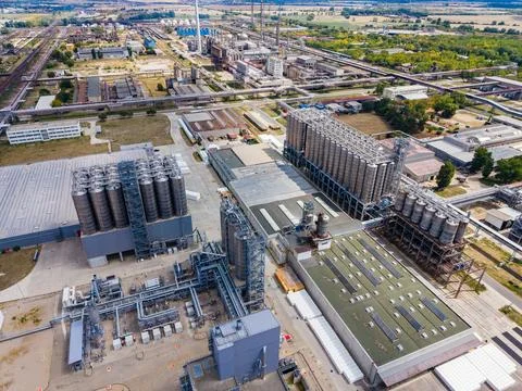 Factory complex during the day showing large storage tanks and production b.. Stock Photos