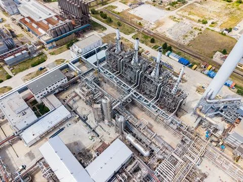 Factory complex with industrial structures and pipelines located in an urba.. Stock Photos