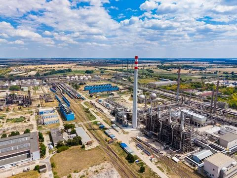 Factory complex located outside a city with tall smokestacks and storage ta.. Stock Photos