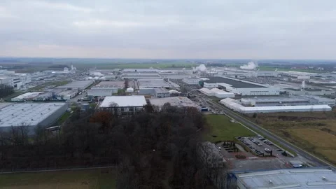 Factory complex seen from above, with smoke rising from chimneys, set again.. Stock Footage 259049029