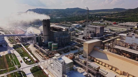 Factory complex with smoke and machinery in the background Stock Footage 340383593